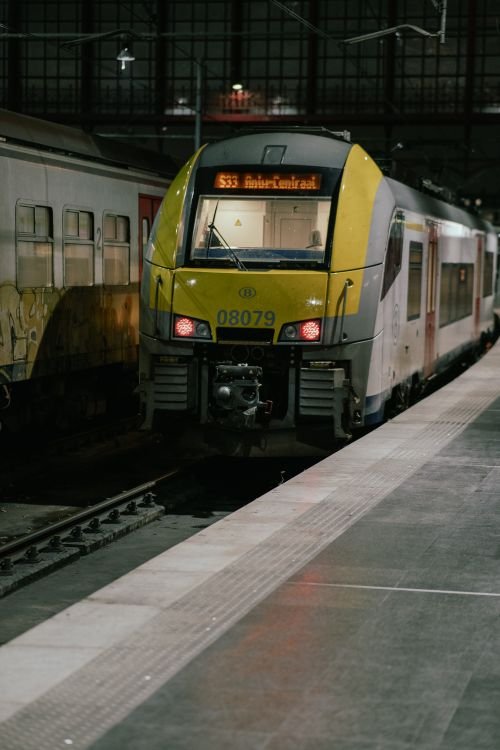 A train at a station platform at night
