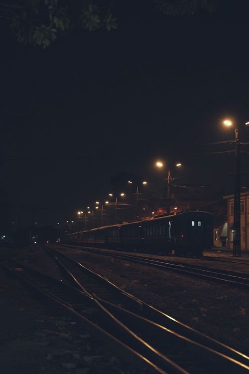 Generic stock photo of a night train at a station platform at night